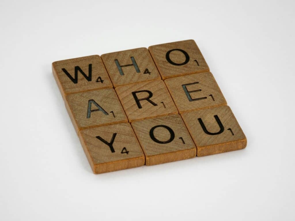 "WHO ARE YOU" spelled using scrabble pieces